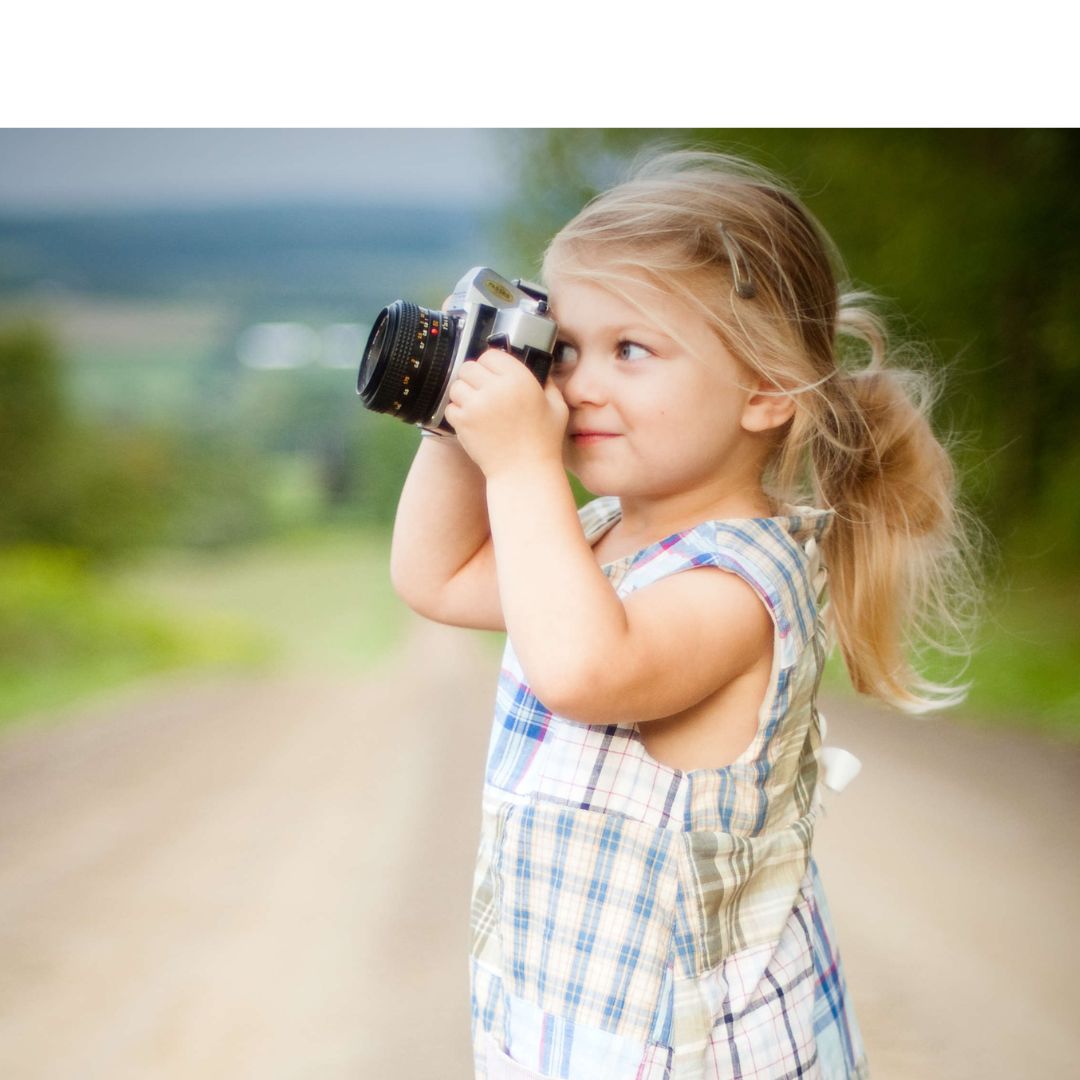 Little girl taking a photo